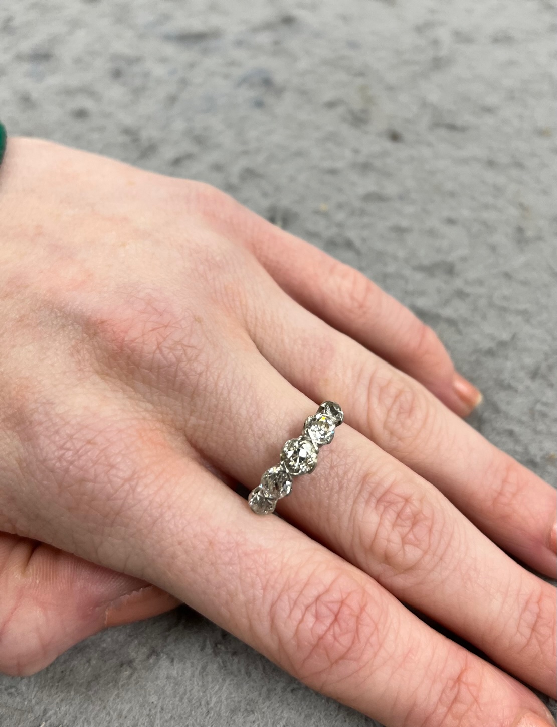 An antique yellow metal and graduated old round cut diamond set half hoop ring, size Q, gross weight 4 grams.